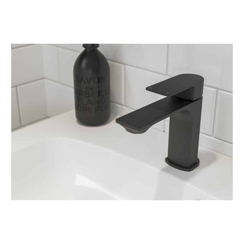 Sleek black bathroom mixer tap on white sink with white tiled background, modern bathroom design, high-quality fixtures, elegant and functional, perfect for contemporary bathrooms.