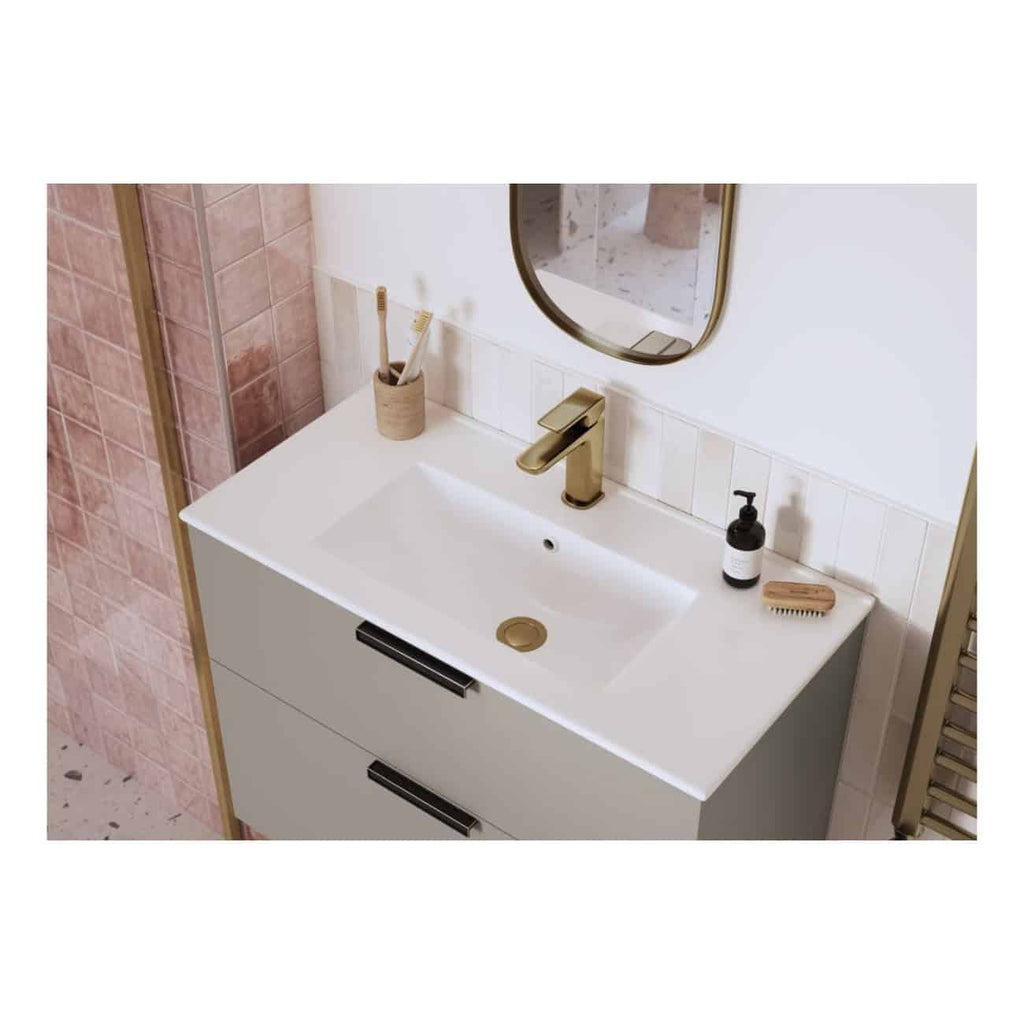 Sleek modern bathroom sink with gold fixtures and minimalistic design, featuring a round mirror, soap dispenser, toothbrush holder, and natural-toned accessories for a stylish bathroom aesthetic.