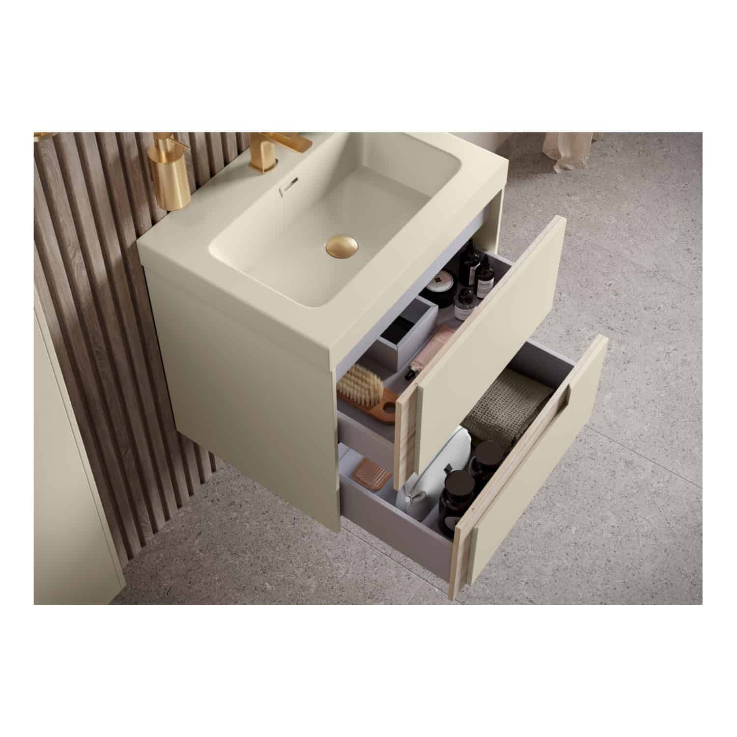 Polished beige bathroom vanity with integrated sink and gold fixtures, featuring open drawers with storage for toiletries and grooming items, set against textured wall and floor.