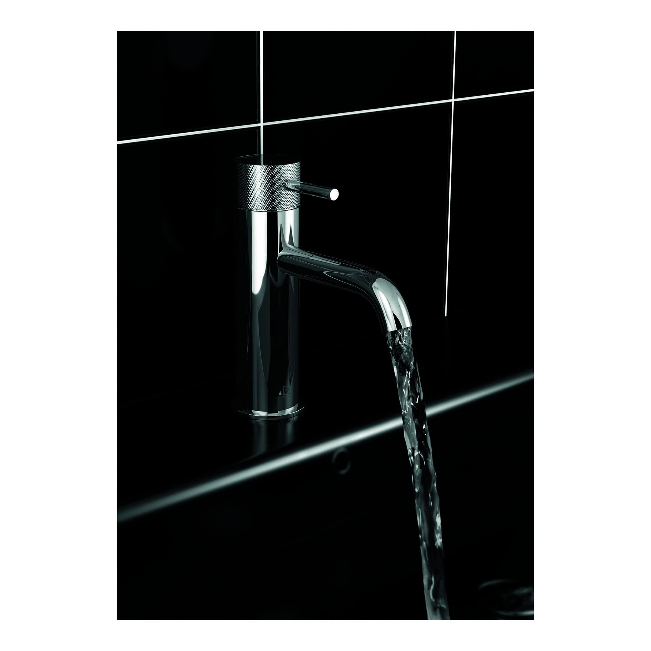 Shiny chrome bathroom tap with flowing water, modern design and black tiled background for luxury bathroom fixtures and fittings.