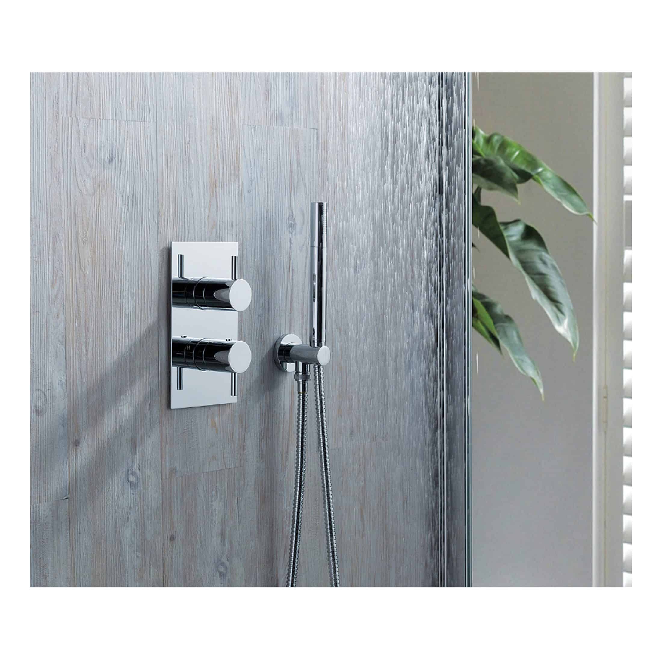 Polished chrome shower control panel with modern design, wall-mounted knobs, and handheld shower head, installed on a sleek wooden-textured bathroom wall.
