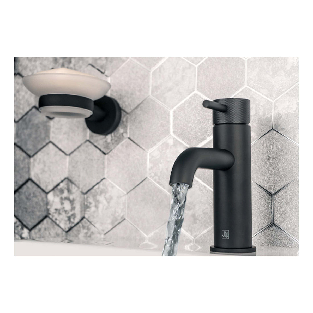 Sleek matte black bathroom tap with modern design, water flowing into a tub, installed on a grey tiled wall, stylish bathroom fixture for contemporary bathroom interiors.