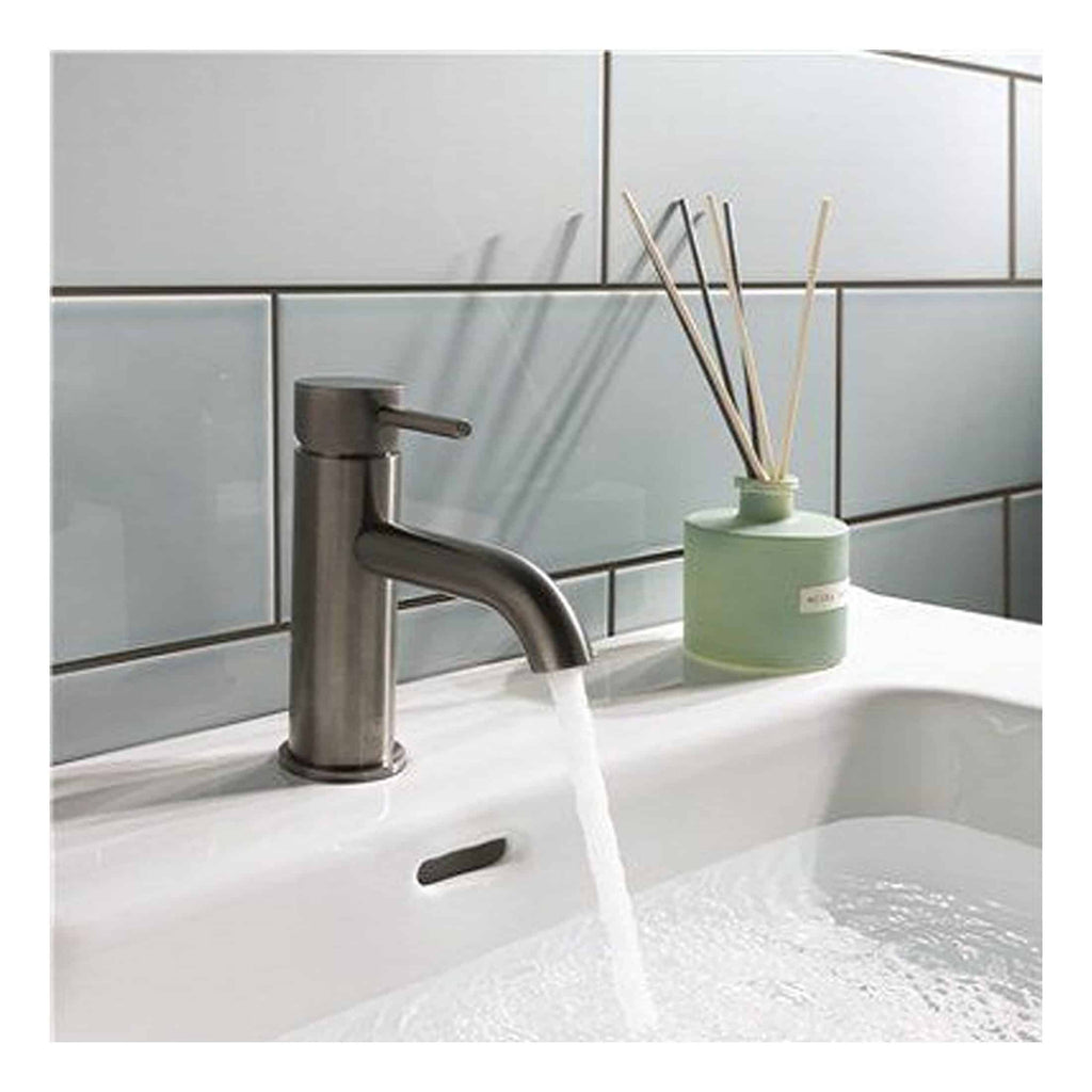 Freshwater bathroom sink with modern stainless steel tap and decorative reed diffuser, clean and stylish bathroom fixtures for a contemporary bathroom design.