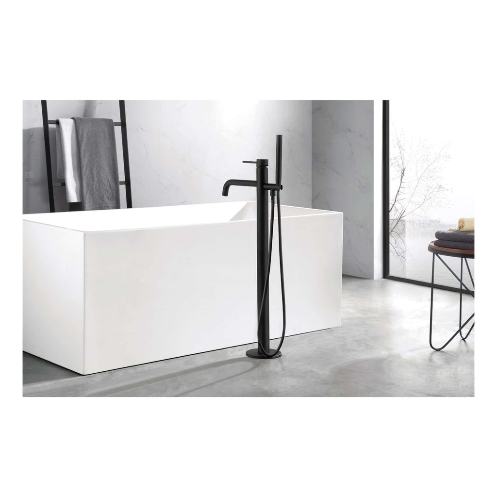 Sleek black floor-mounted freestanding bathtub tap with matching hand shower in modern bathroom with minimalist design.