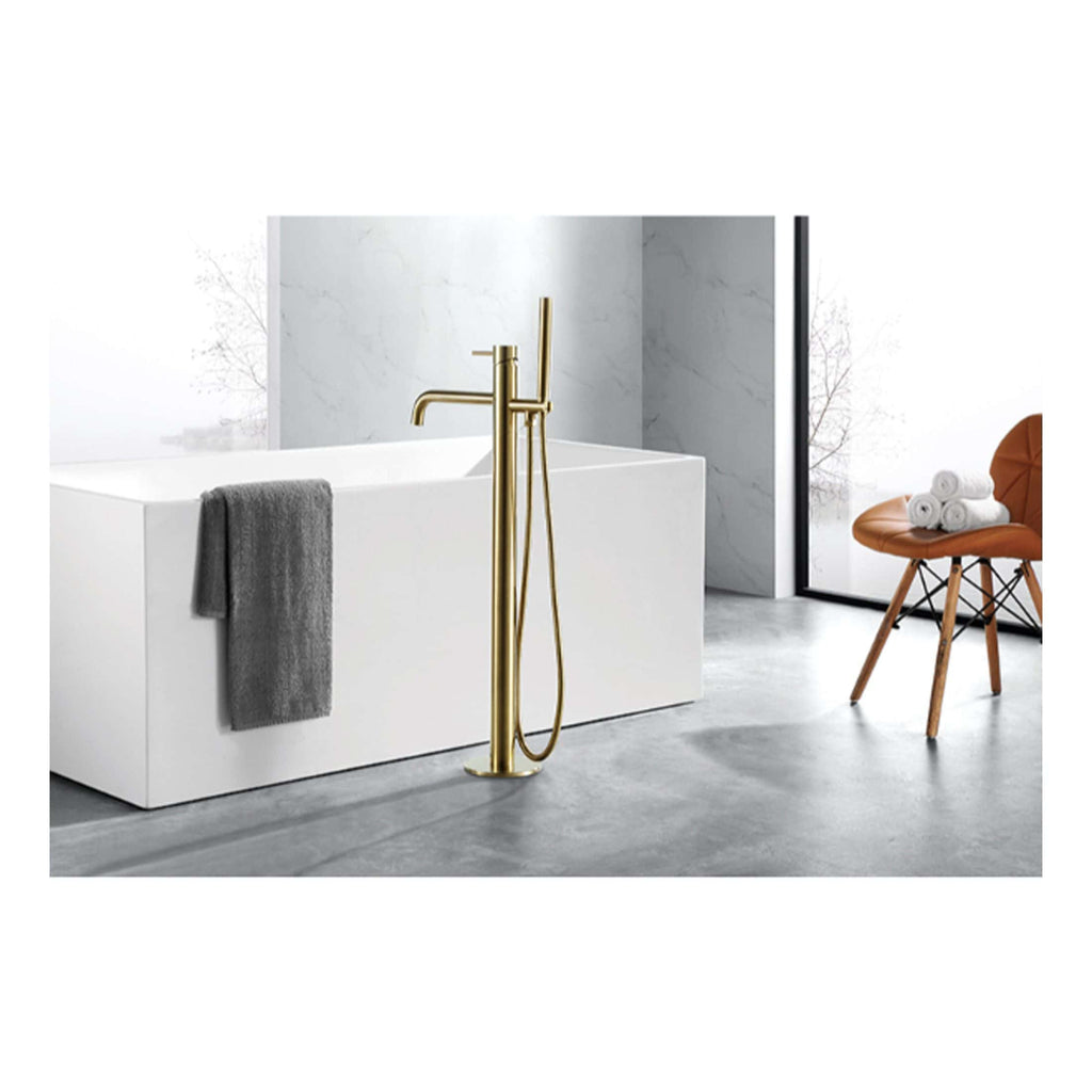 Luxurious freestanding bathtub with modern gold floor-mounted faucet in a contemporary bathroom featuring marble walls and minimalist design.