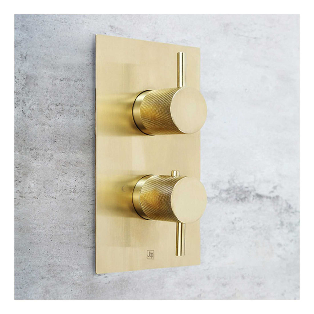Sleek gold digital shower control panel with two knobs for precise temperature and flow regulation, enhancing modern bathroom aesthetics and functionality.