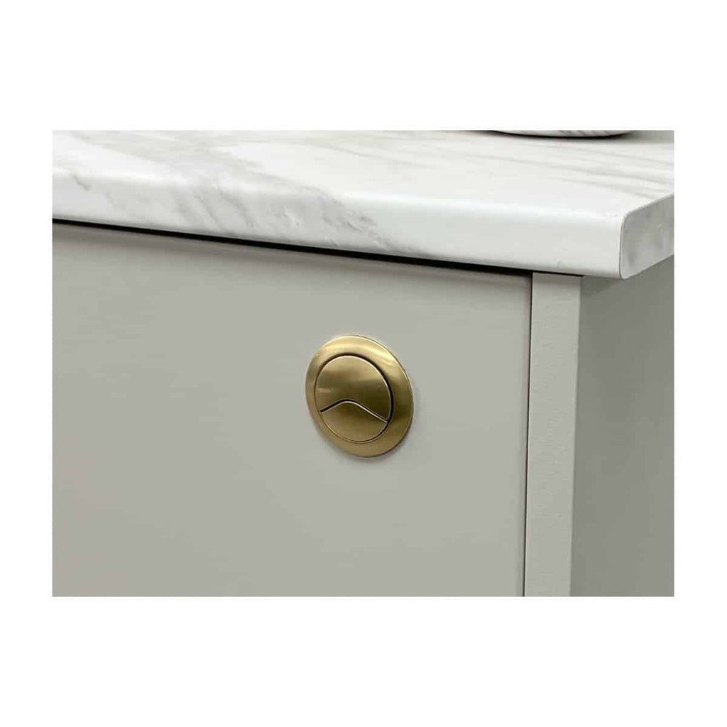 Polished gold bathroom drawer knob on a modern cabinet with marble countertop, highlighting luxury brass fixtures for stylish bathroom furniture and accessories.