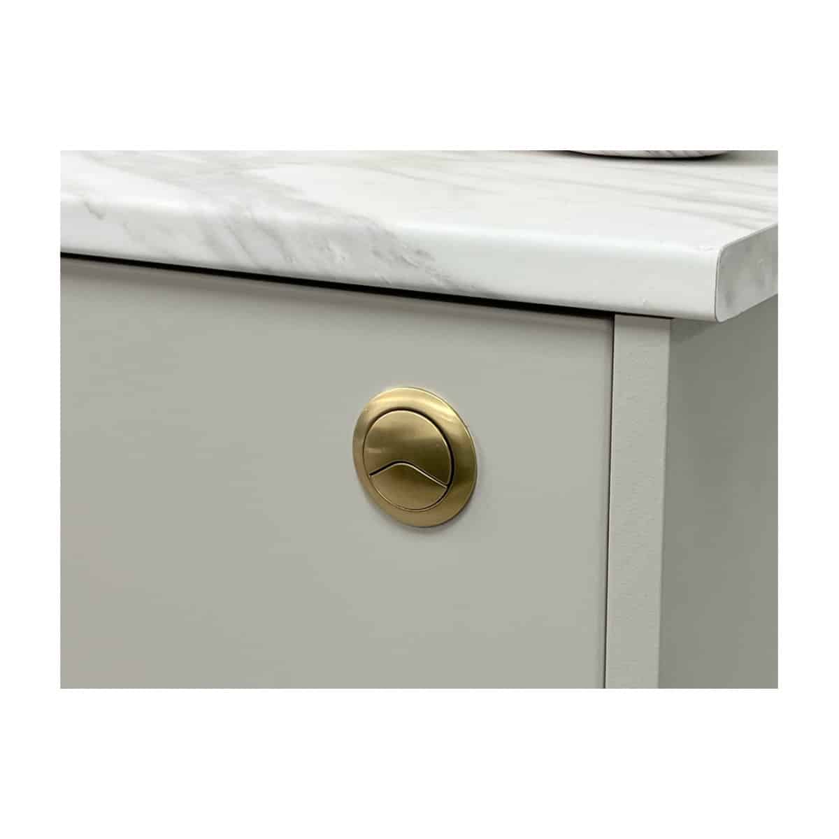 Polished gold bathroom drawer knob on a modern cabinet with marble countertop, highlighting luxury brass fixtures for stylish bathroom furniture and accessories.