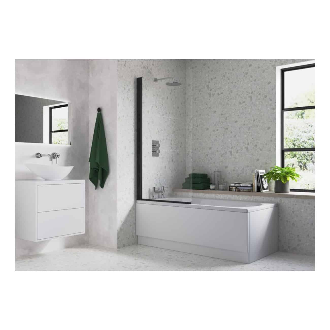 Sleek modern bathroom featuring a white bathtub with a glass screen, black-framed windows, green towels, and contemporary accessories in a bright, minimalist space.