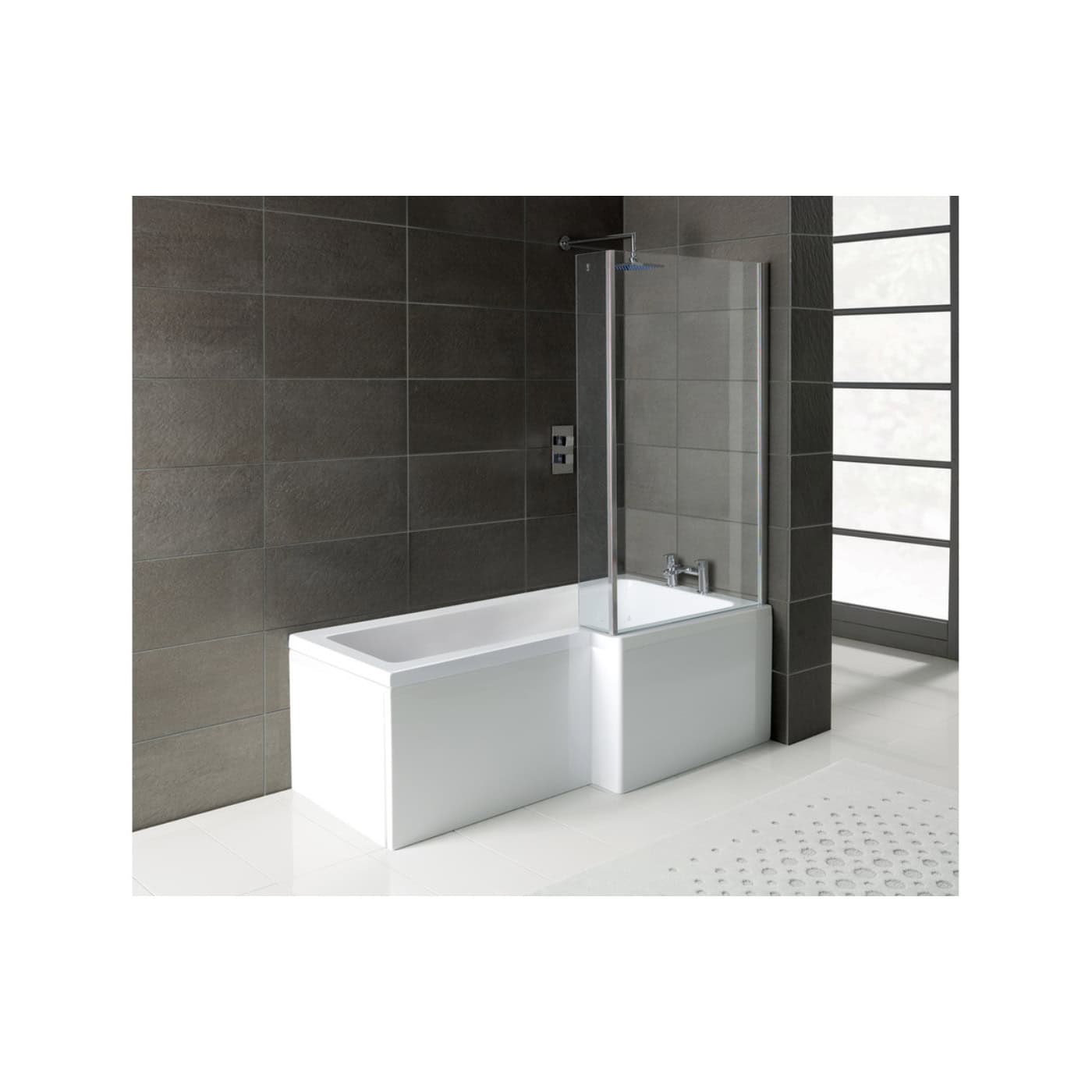 Sleek modern bathtub with partial glass screen in contemporary bathroom with dark wall tiles and large window for natural light.
