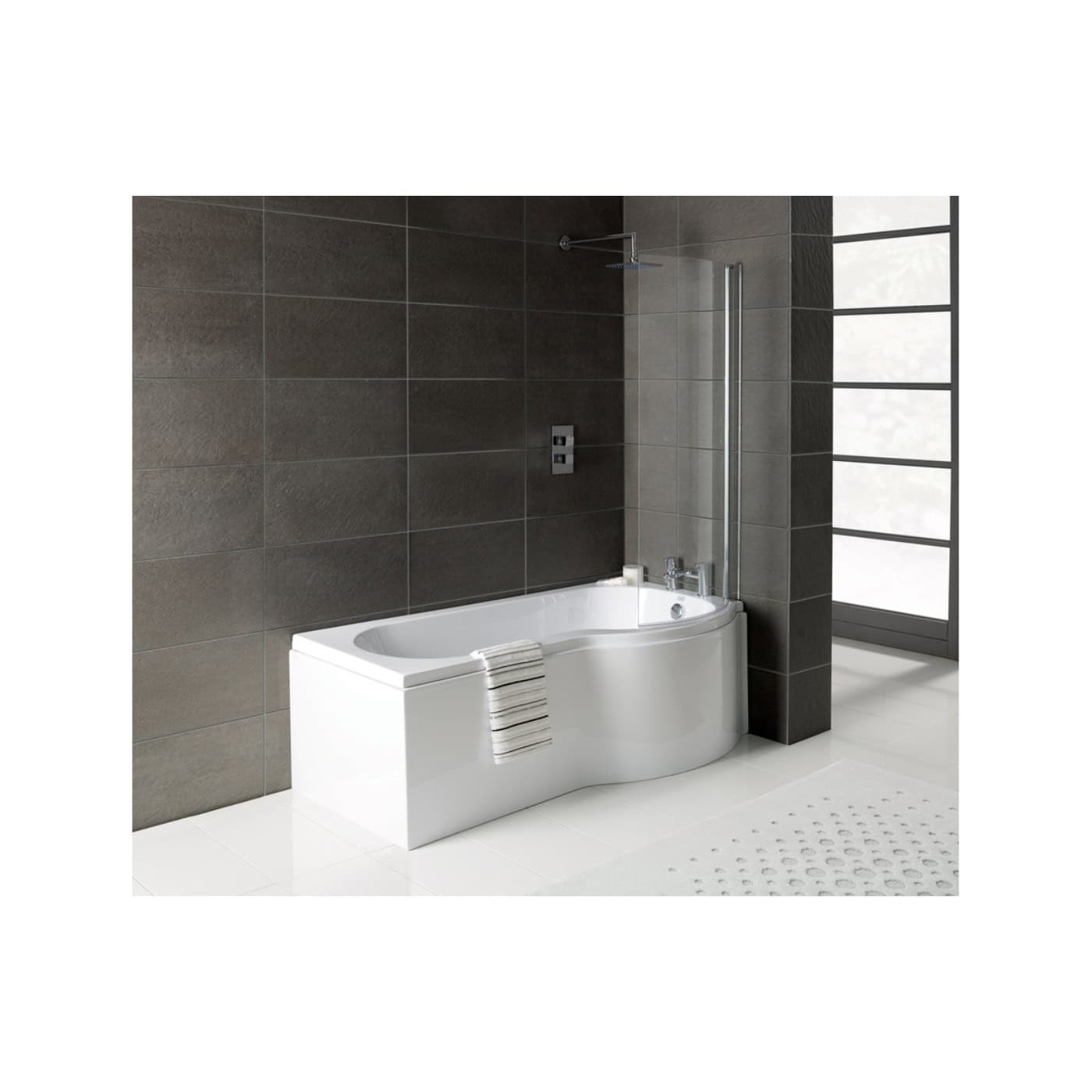 A sleek white corner bathtub with a handheld shower and glass panel, set against dark tiled walls and a controllable shower head, in a modern, minimalist bathroom design.