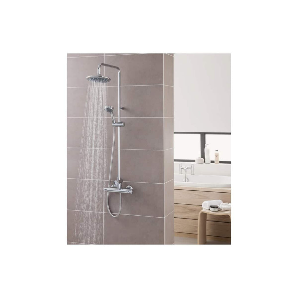 Sleek chrome shower system with rain shower head and handheld attachment ideal for modern bathrooms with tiled walls.