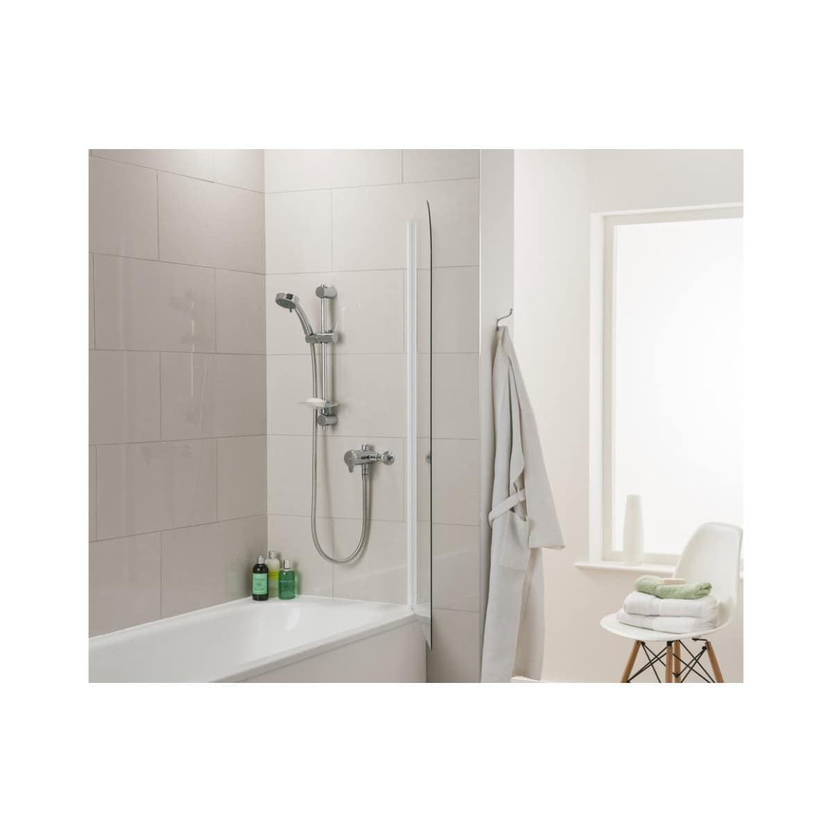 Shower area with modern chrome fixtures, shower screen, and white tiled walls in a contemporary bathroom setting.
