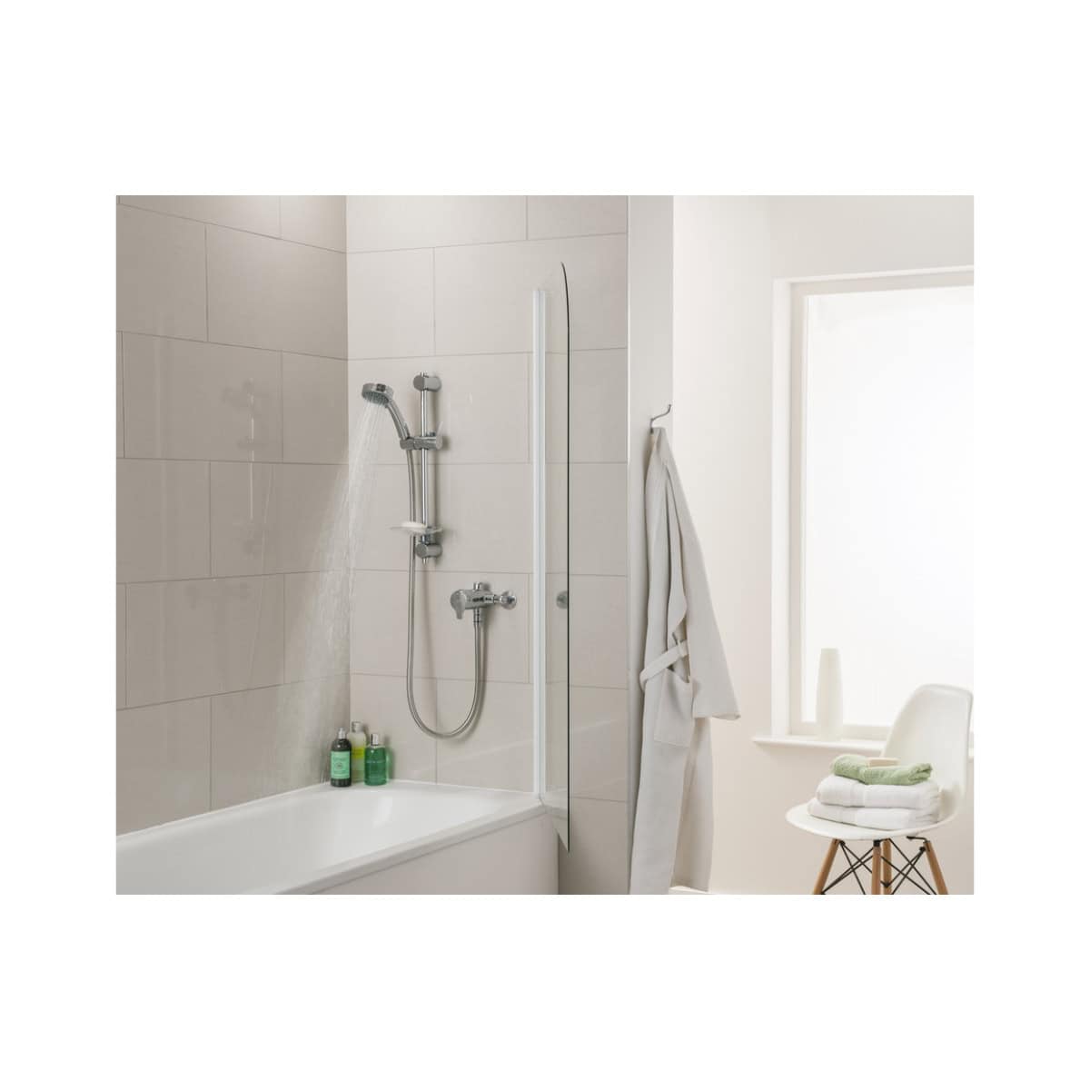 Modern minimalist bathroom shower area with a sleek chrome hand shower, white tiled walls, a bathtub, and a cozy corner with towels and natural light from a large window.