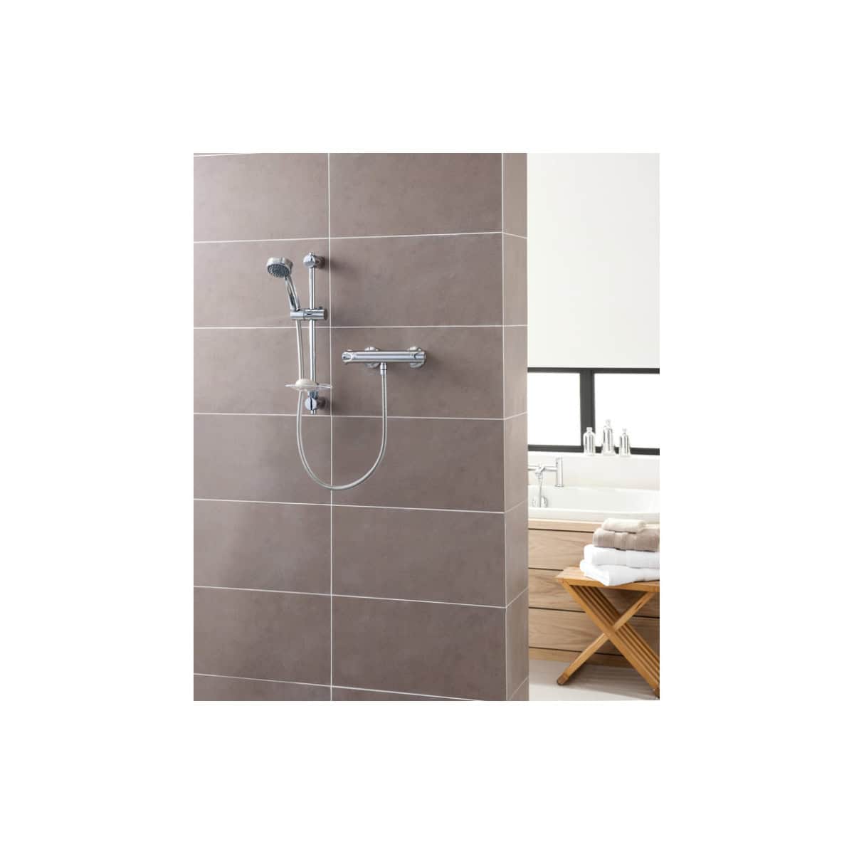 Modern chrome shower head and handheld shower on a tiled wall, part of luxurious bathroom bathroom fixtures and fittings, designed for comfort and style, popular in contemporary Bubly Bathrooms.