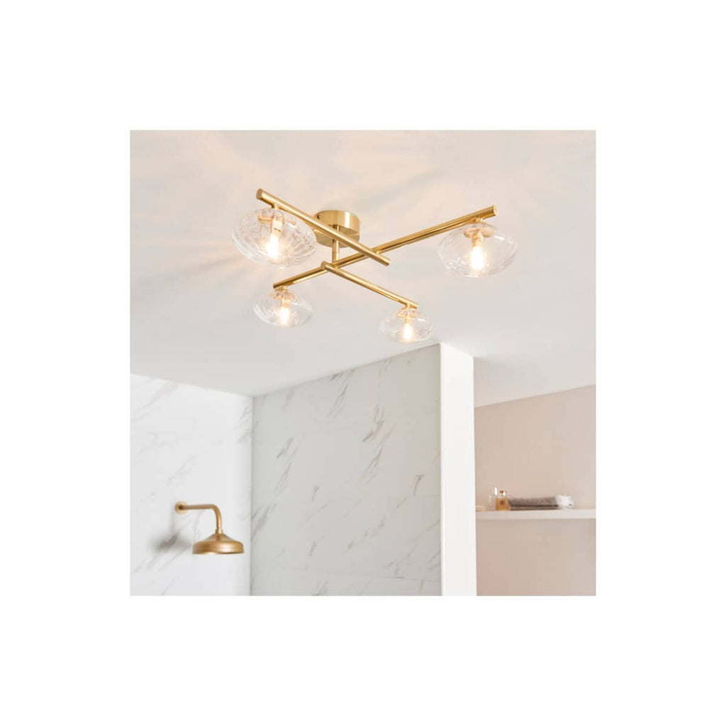 Modern gold ceiling light fixture with four glass shades, ideal for luxury bathroom lighting, enhancing contemporary bathroom decor and creating a stylish atmosphere.