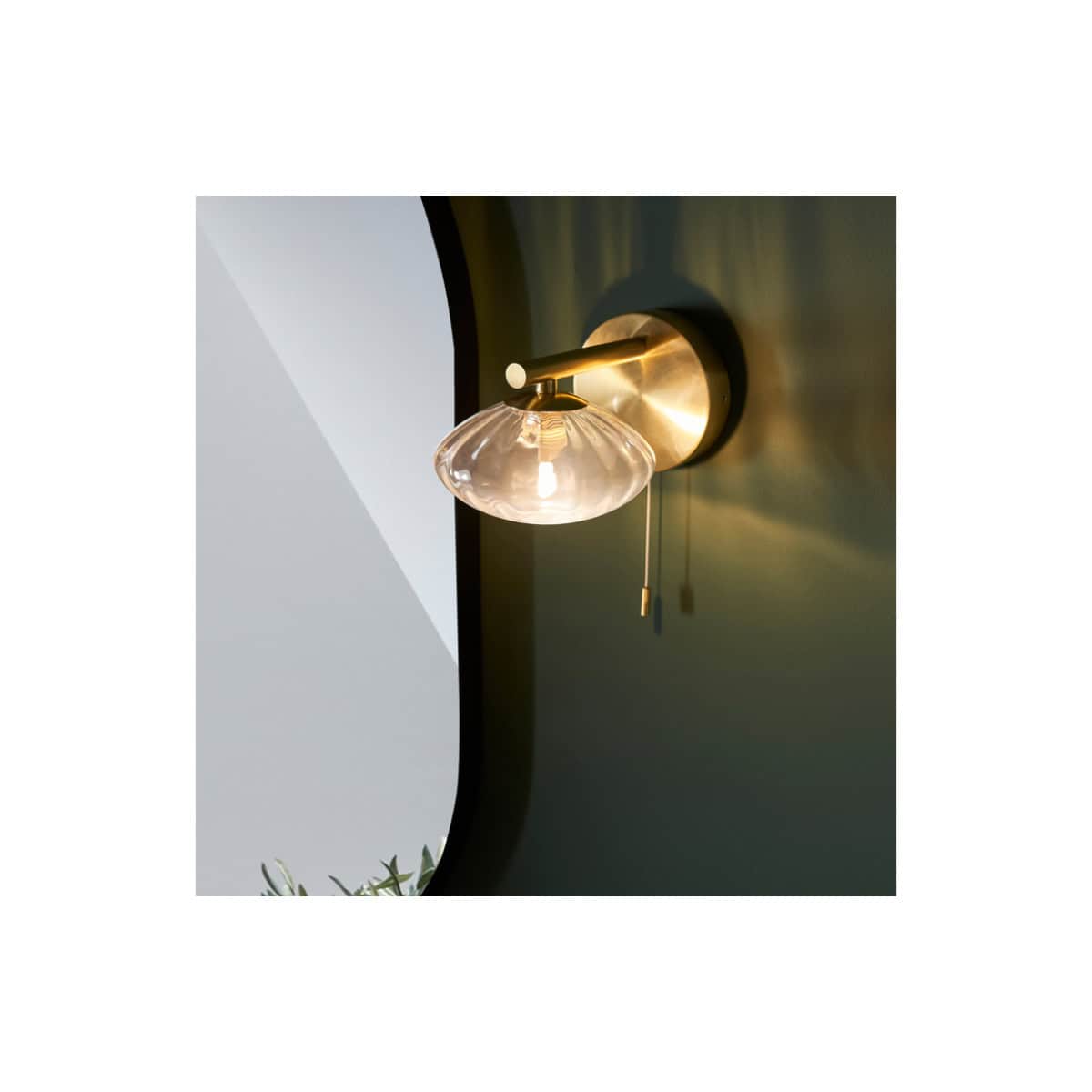 Elegant modern wall sconce with a glass shade and brass finish, perfect for contemporary bathroom lighting. Designed to add warmth and style to your Bubly Bathrooms.