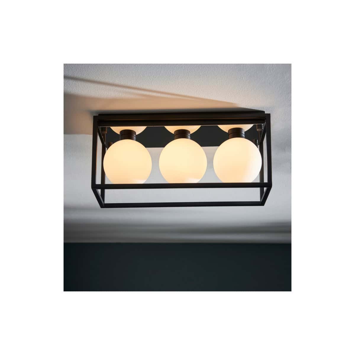 Modern black framed ceiling light fixture with three frosted glass globes, ideal for contemporary bathroom lighting solutions.