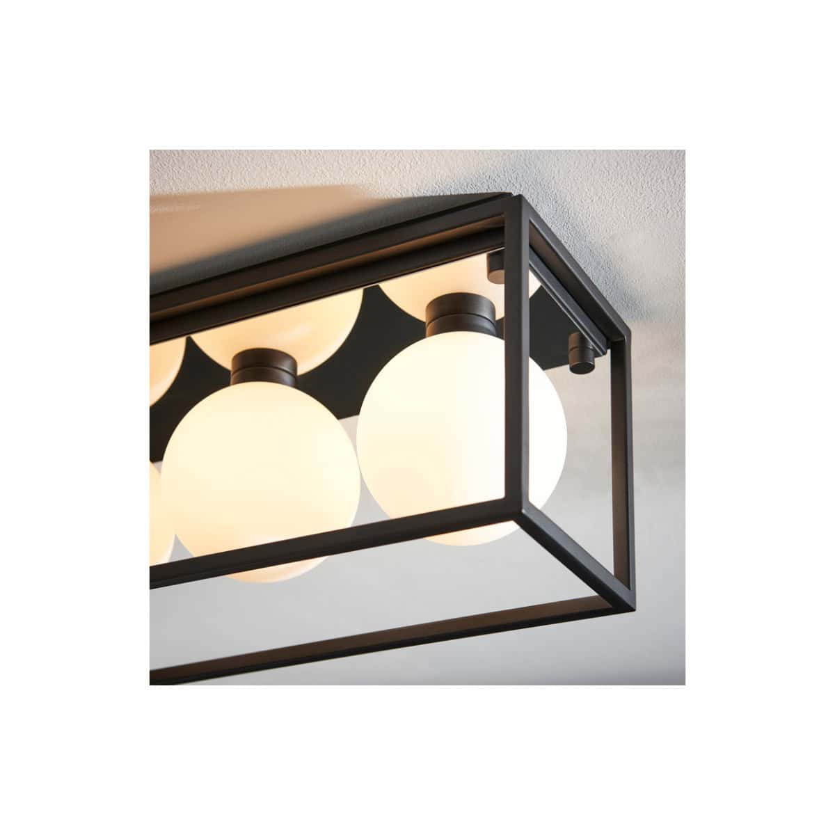 Bright modern black-framed bathroom ceiling light fixture with multiple frosted globes, ideal for contemporary bathroom decor and optimal lighting.