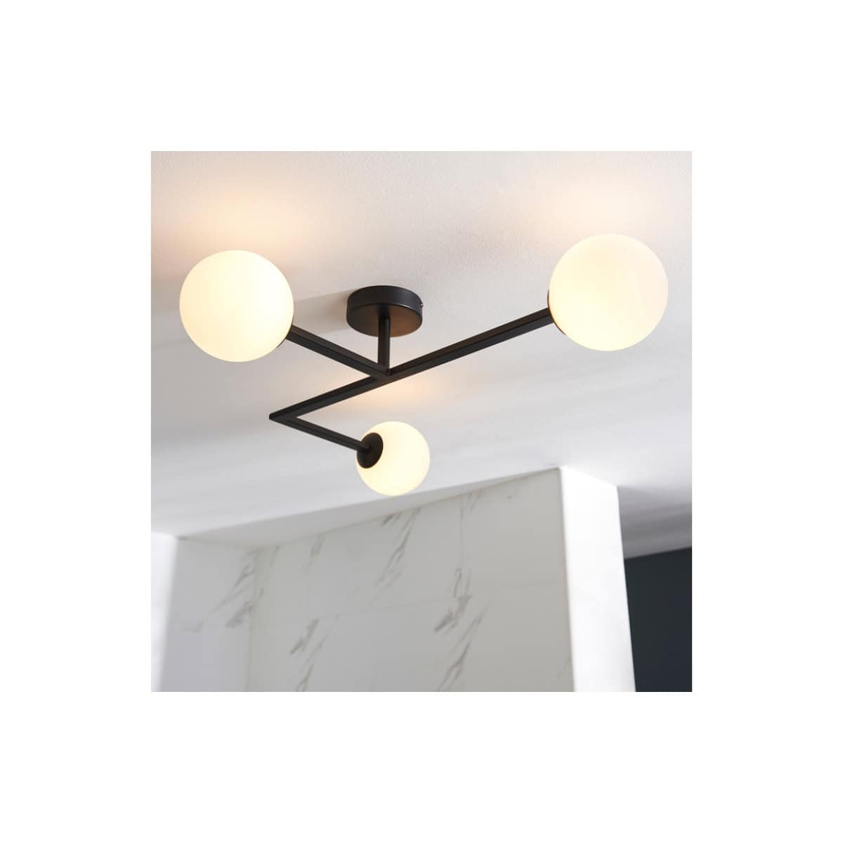 Contemporary black metal bathroom ceiling light fixture with three globular white glass shades, ideal for modern bathroom lighting design.