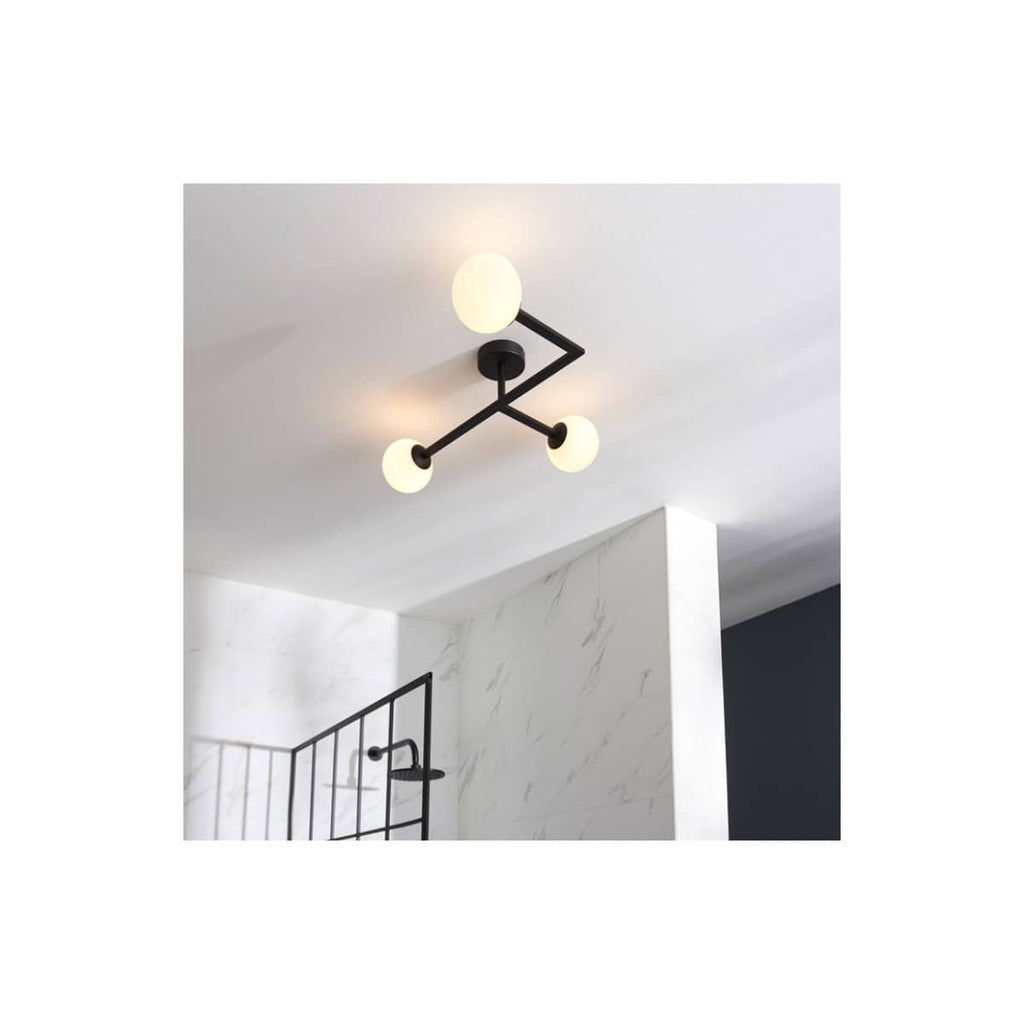 Contemporary black metal ceiling light fixture with three adjustable globe bulbs, ideal for modern bathrooms and stylish interior lighting.