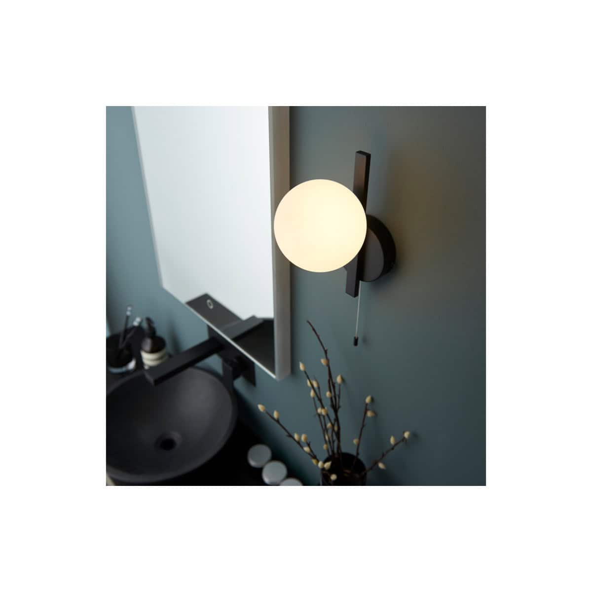 Sleek modern wall sconce with spherical frosted glass and black metal accents, perfect for contemporary bathroom decor.