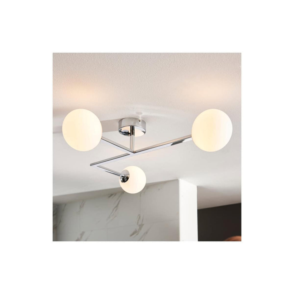 Contemporary chrome bathroom ceiling light fixture with three round frosted glass globes, ideal for modern bathroom lighting solutions.