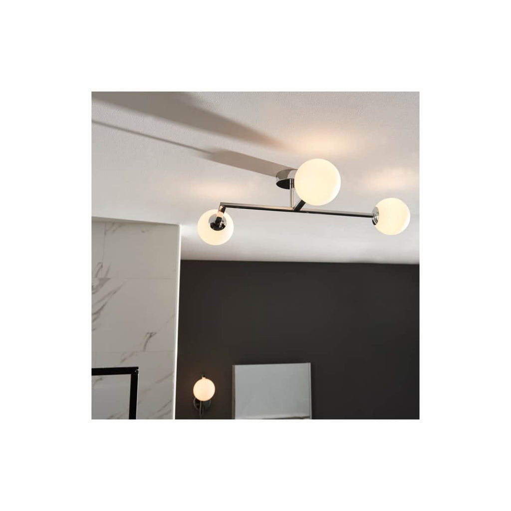 Sleek modern ceiling light fixture with three globe-shaped bulbs in a contemporary bathroom setting, enhancing bathroom lighting design and aesthetics.