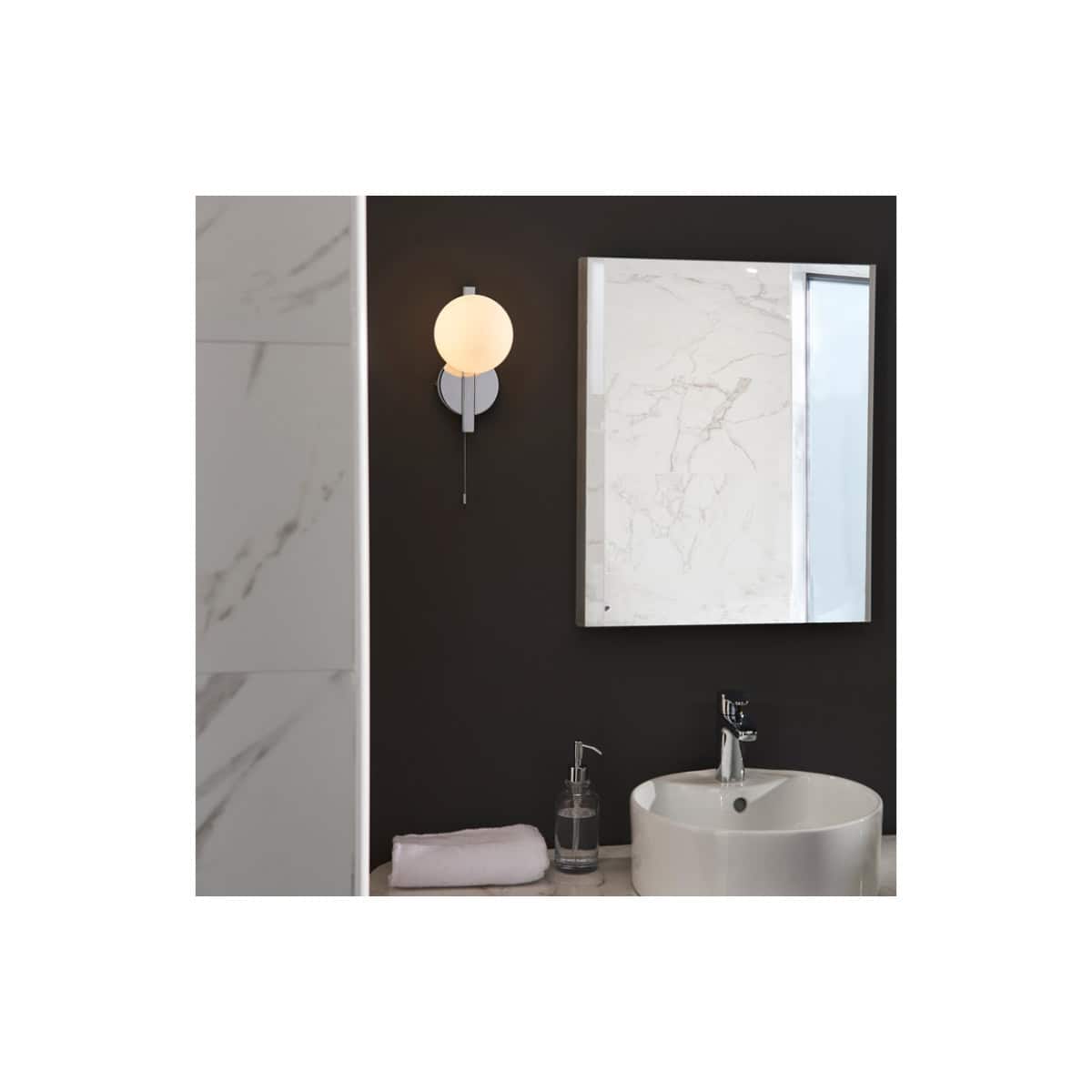 Sleek modern bathroom with marble accents, black wall, and minimalist fixtures featuring a stylish mirror and wall sconce for contemporary bathroom design.