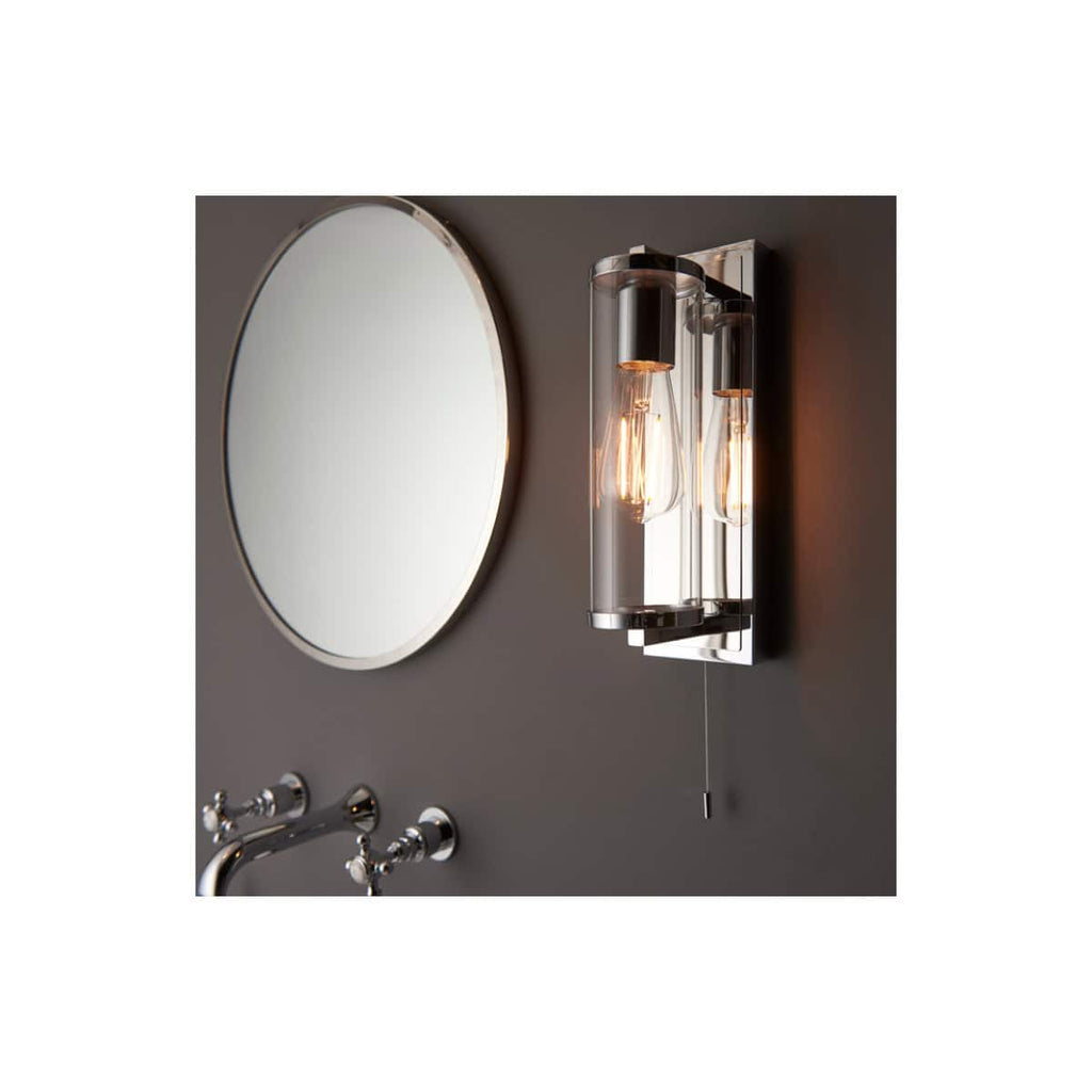 Elegant modern wall-mounted bathroom light fixture with exposed filament bulbs and chrome accents, ideal for contemporary bathroom lighting design.