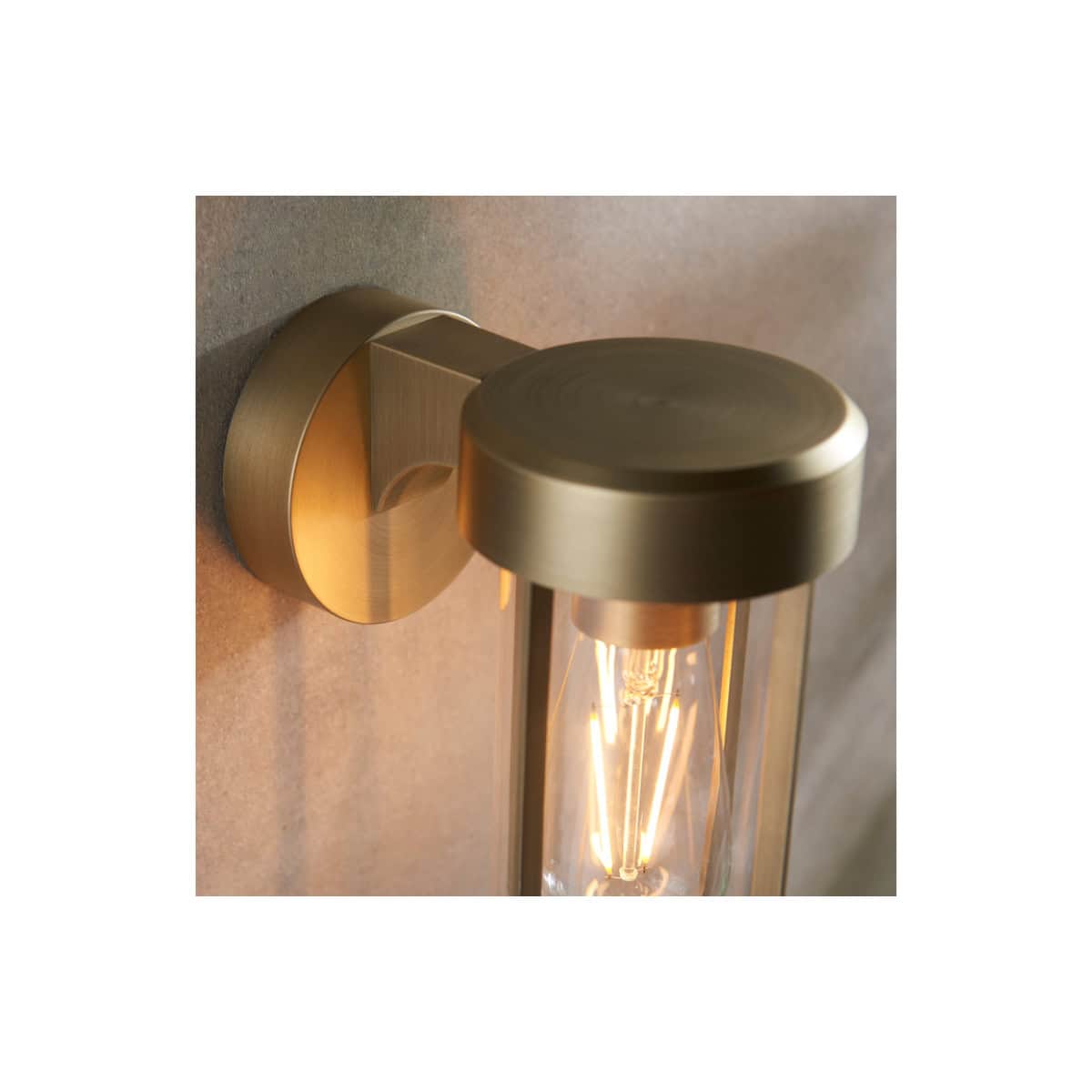 Sleek modern brass wall-mounted bathroom light fixture with exposed filament bulb, perfect for contemporary bathroom lighting. Designed for a stylish and functional bathroom renovation.