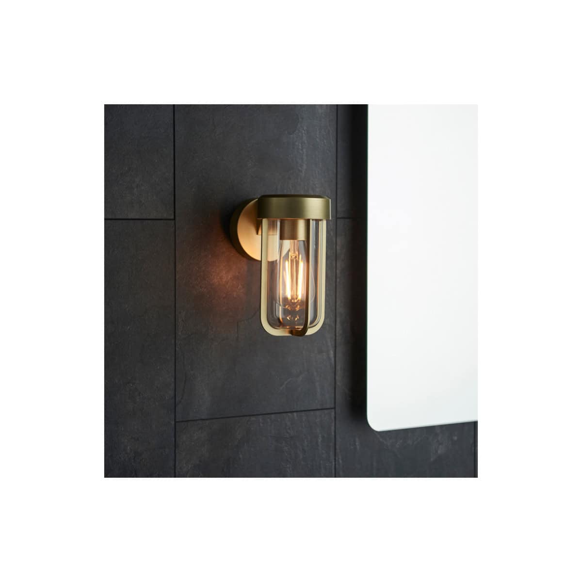 Stylish modern wall sconce light fixture with brass finish, ideal for contemporary bathroom decor and ambient lighting. Perfect for accenting bathroom walls with elegant illumination.