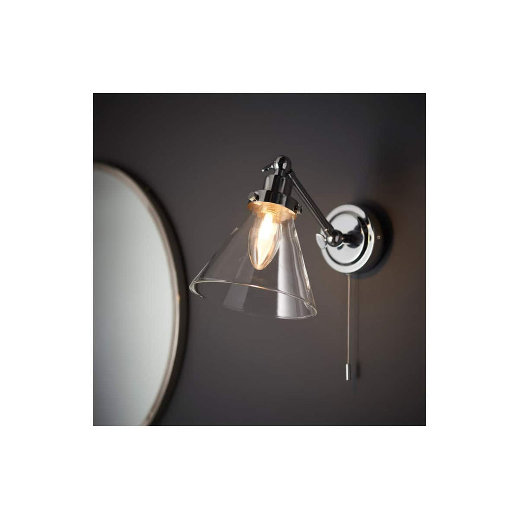 Elegant modern bathroom wall light with a glass shade and chrome finish, ideal for contemporary bathroom designs. Perfect for creating a stylish and functional lighting solution in your bathroom space.