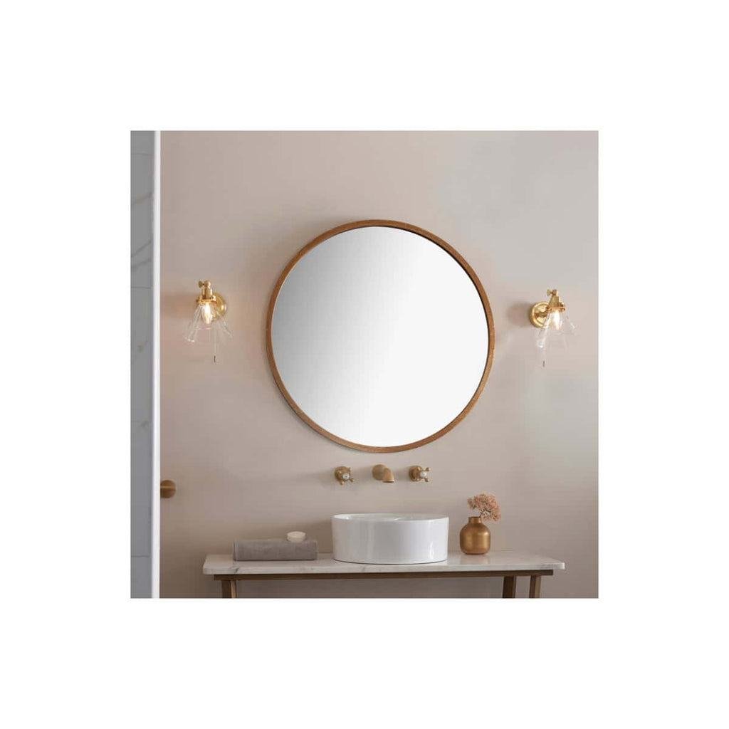 Elegant bathroom vanity with round mirror, stylish wall sconces, and modern sink, perfect for contemporary Bubly bathrooms with sophisticated decor and warm lighting.