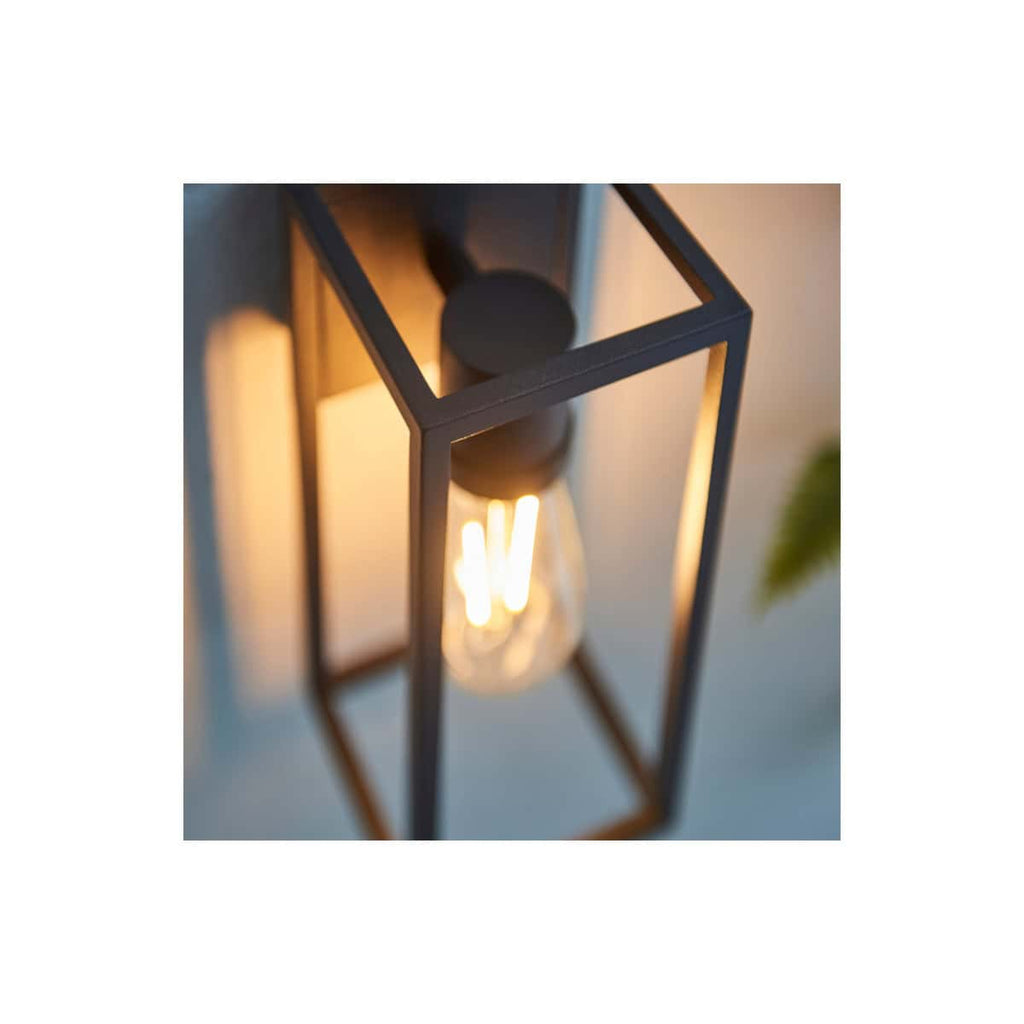 Modern black metal lantern with warm LED Edison-style bulb, perfect for stylish bathroom lighting and decor. Elegant and contemporary design for a sophisticated bathroom atmosphere.