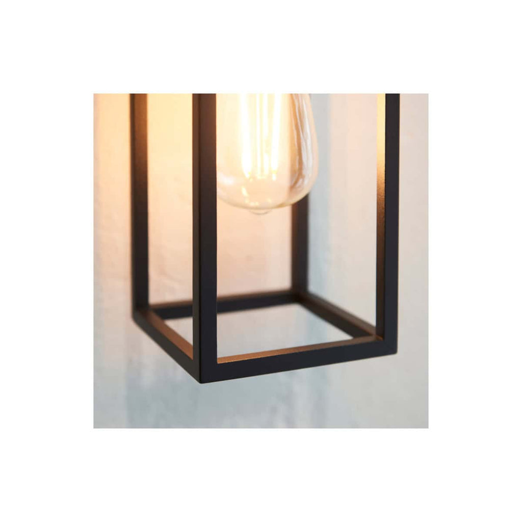 Modern black metal pendant light with an exposed filament bulb, ideal for contemporary bathroom or home decor lighting.