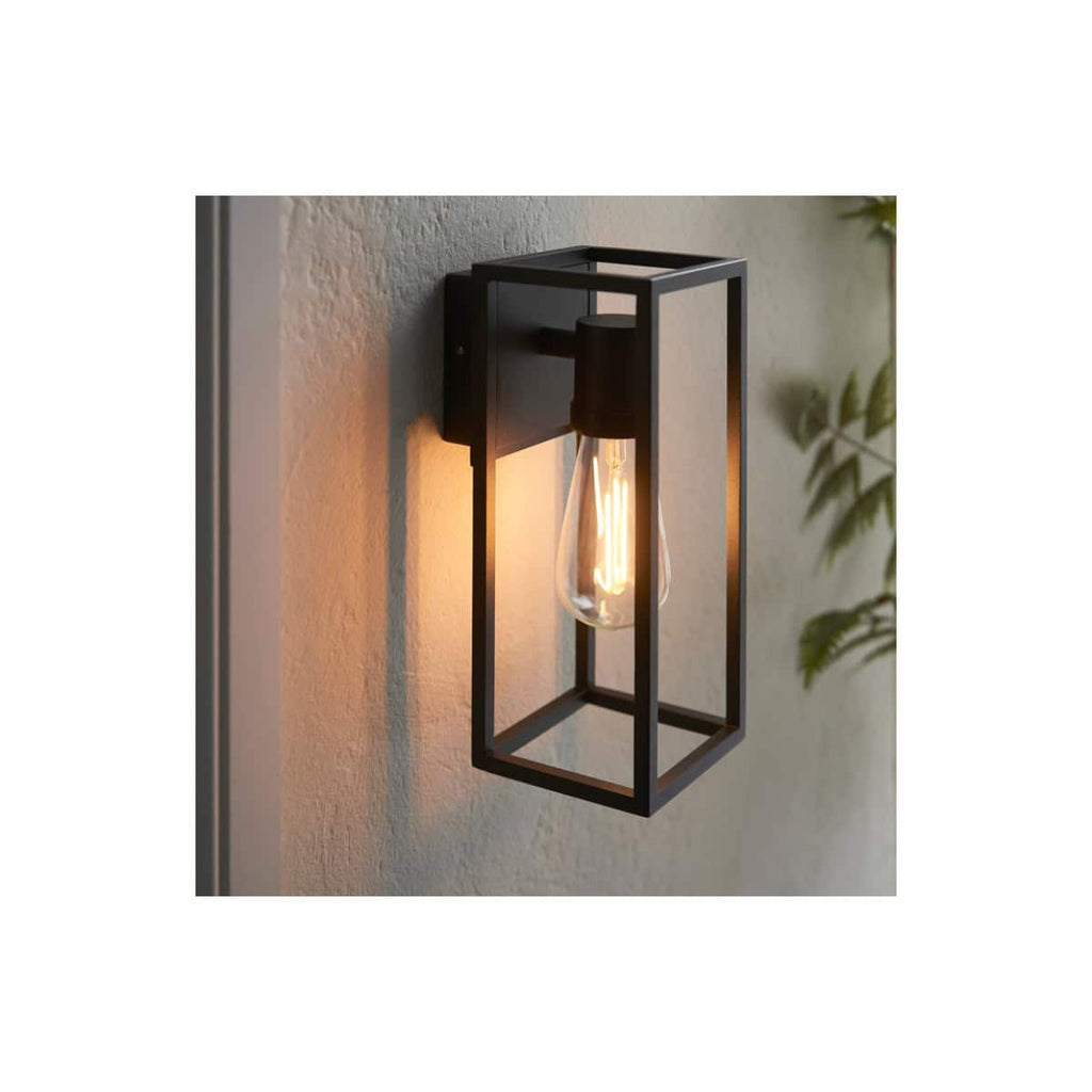 Sleek black metal wall light with an exposed filament bulb, perfect for modern bathroom lighting. Elegant, minimalist design enhances contemporary bathroom decor.