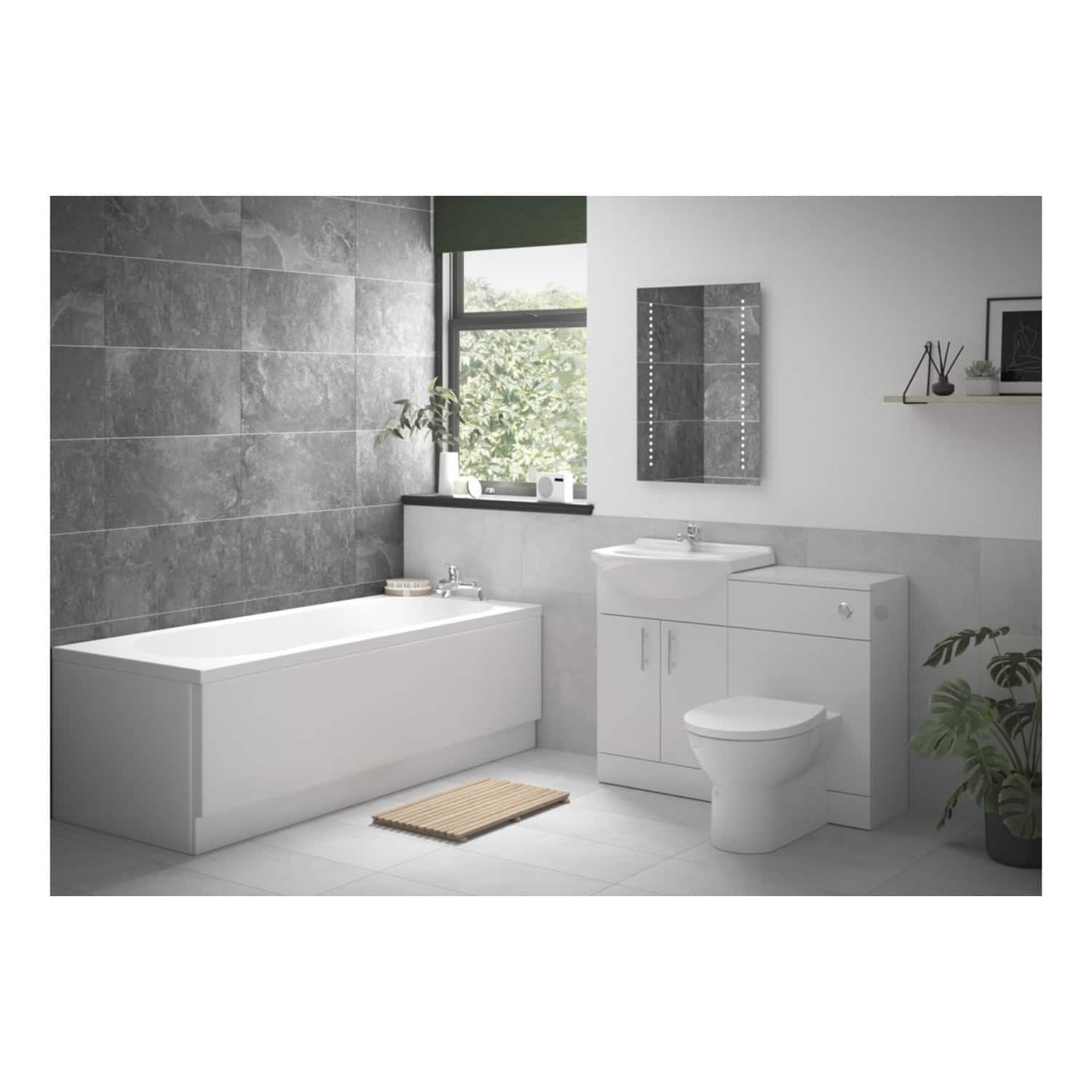 Modern bathroom with white bathtub, vanity unit, toilet, wall-mounted mirror, and natural light. Featuring contemporary fixtures and a minimalist design for a sleek, stylish bathroom upgrade.