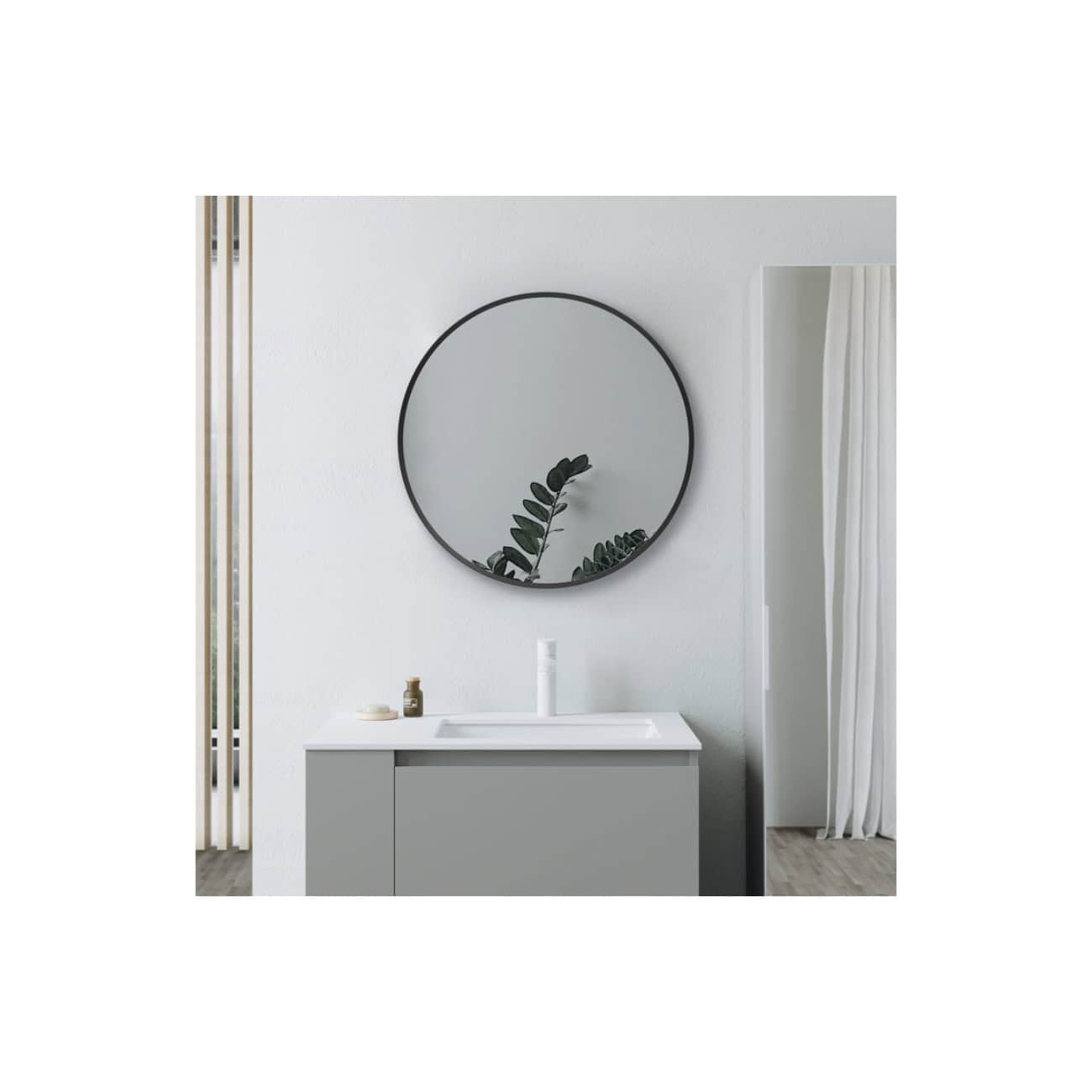 Minimalist bathroom vanity with a round mirror, white sink, and neutral décor, showcasing sleek design elements and modern style for elegant bathroom interiors.