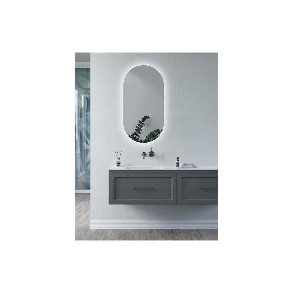 Modern bathroom vanity with dark grey cabinet, white countertop, oval backlit mirror, and black fixtures, creating a sleek and contemporary look for stylish bathrooms.