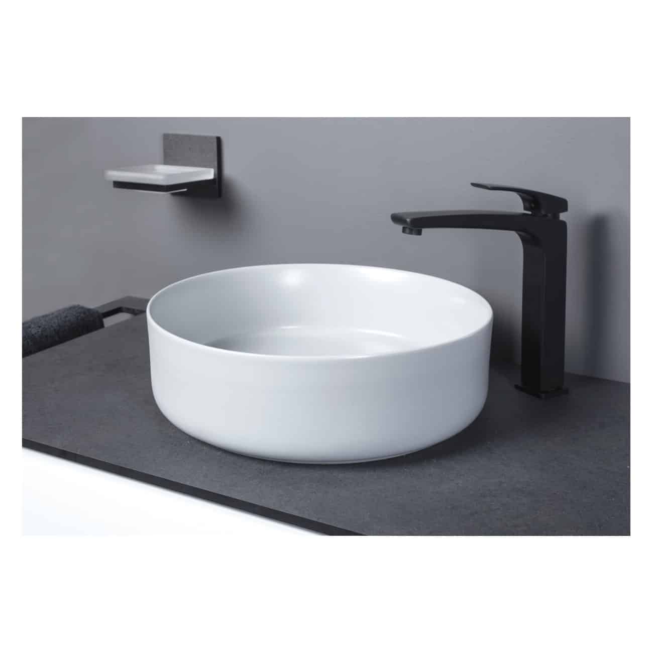White modern bathroom vessel sink with black matte faucet and minimalist wall-mounted soap dish, sleek and contemporary design for luxury washrooms.
