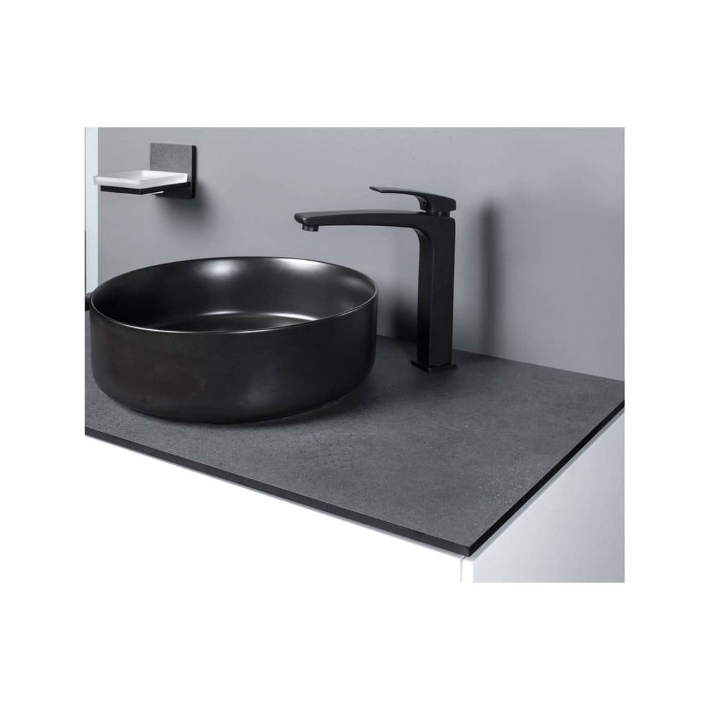 Sleek black vessel bathroom sink with modern matte black faucet and wall-mounted soap dish, designed for contemporary bathrooms for a minimalist and stylish look.