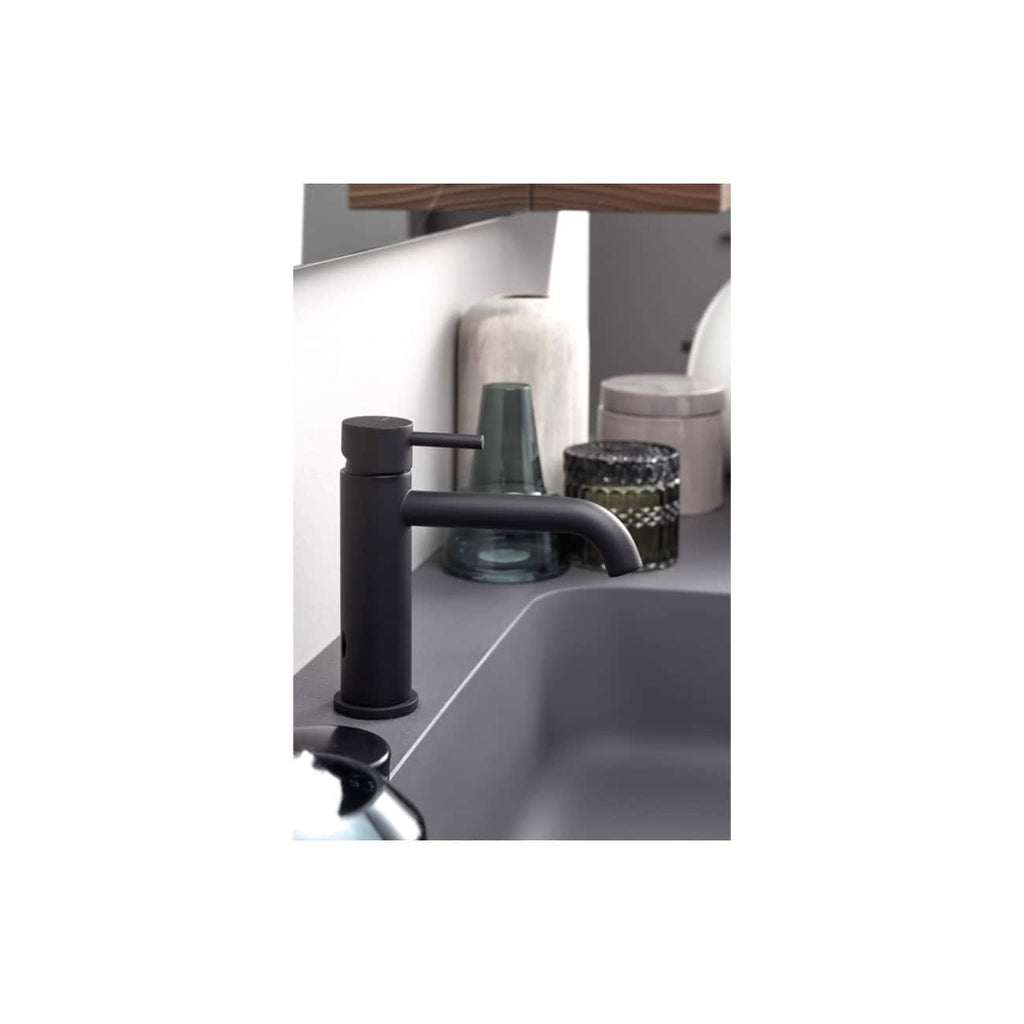 Black bathroom sink mixer tap with modern matte finish and curved spout. Suitable for contemporary bathroom designs, it provides a sleek and functional addition to any stylish bathroom setup.