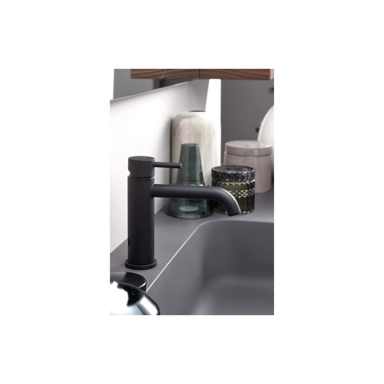 Black bathroom sink mixer tap with modern matte finish and curved spout. Suitable for contemporary bathroom designs, it provides a sleek and functional addition to any stylish bathroom setup.