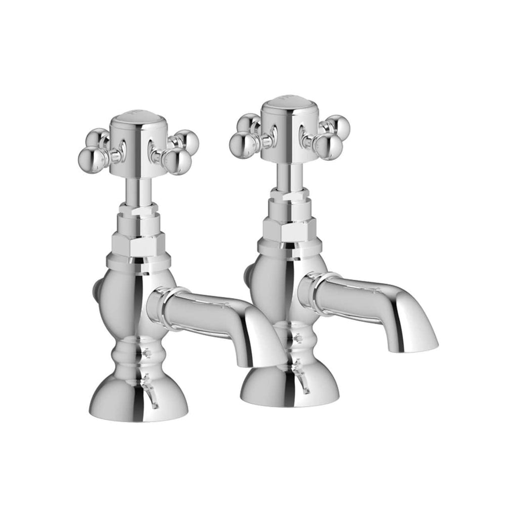 Polished chrome Victorian-style bathroom taps with cross handles, vintage design for classic bathroom interiors.