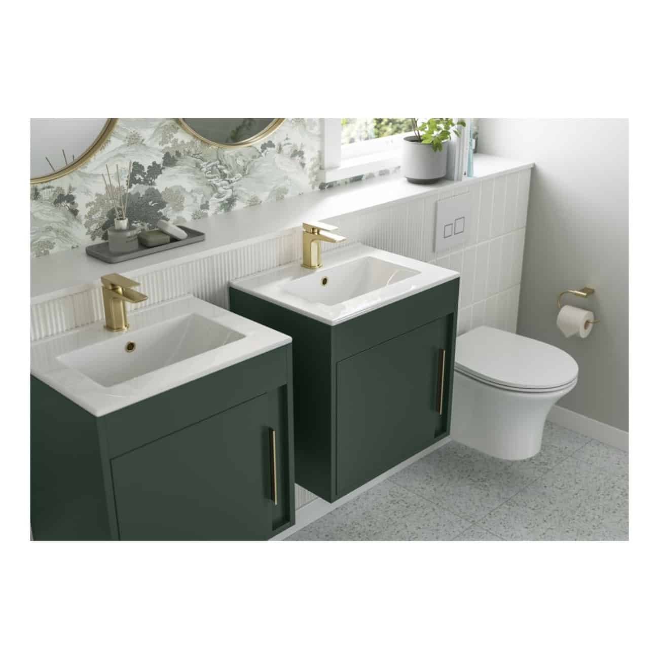 Contemporary bathroom vanity units with dual sinks, featuring stylish gold fixtures, modern cabinetry in dark green, and a sleek toilet for a functional and elegant space.