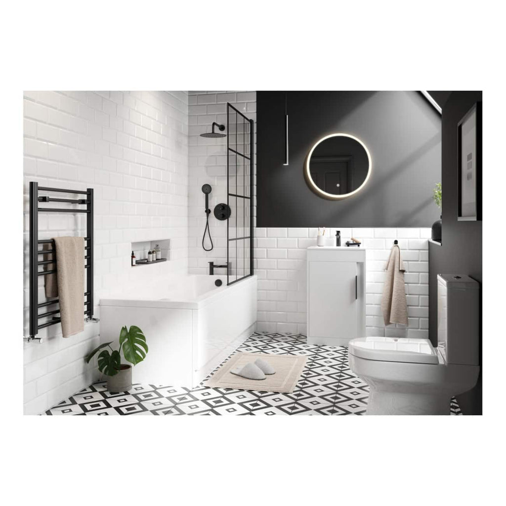 Modern monochrome bathroom with black and white tiles, sleek white bathtub, wall-mounted vanity, illuminated round mirror, and minimalist fixtures, creating a stylish and contemporary space.