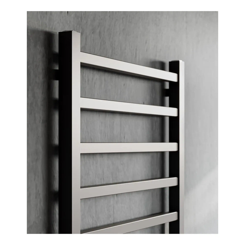 Sleek stainless steel towel radiator in modern bathroom, ideal for heat and towel drying, complementing contemporary bathroom decor.