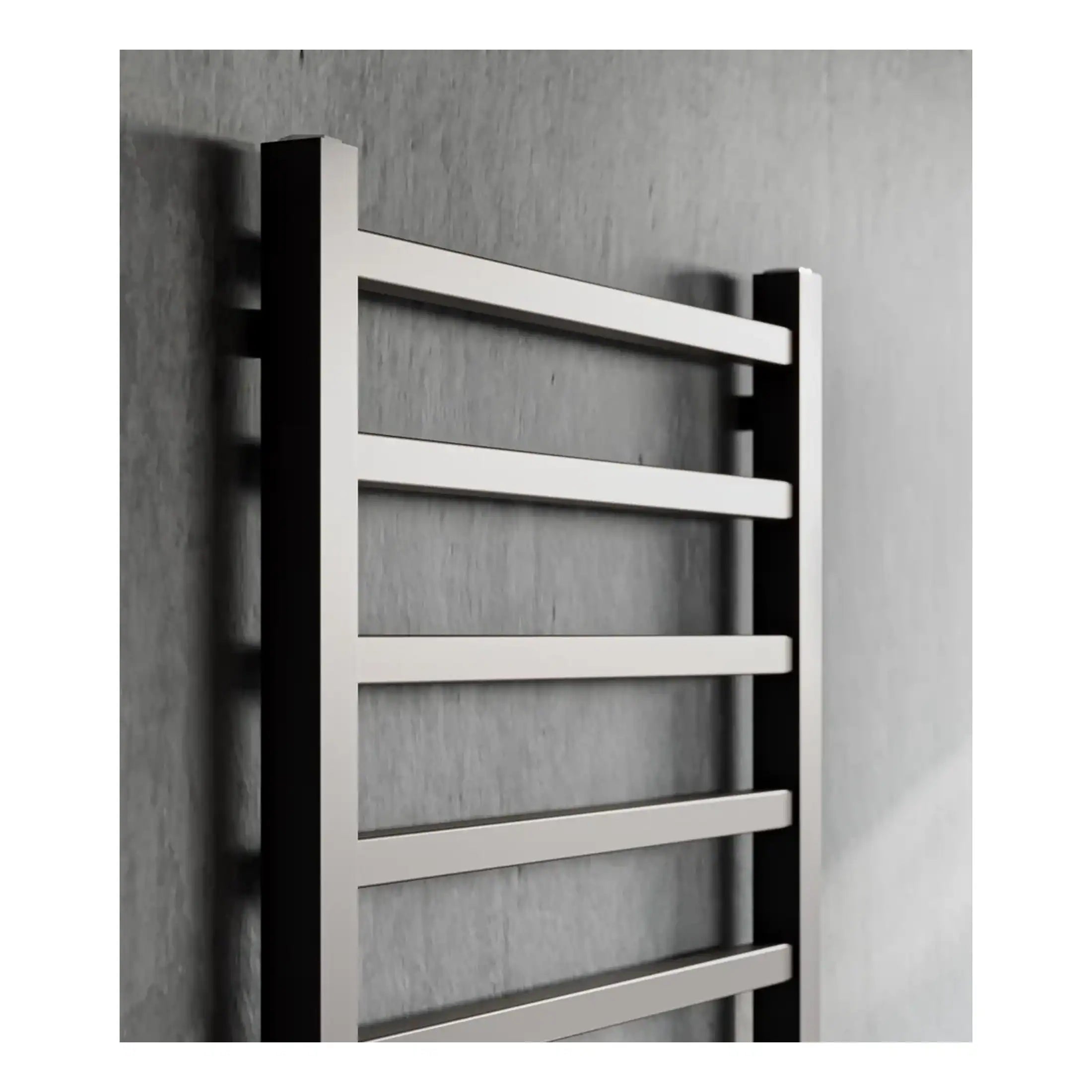 Sleek stainless steel towel radiator in modern bathroom, ideal for heat and towel drying, complementing contemporary bathroom decor.