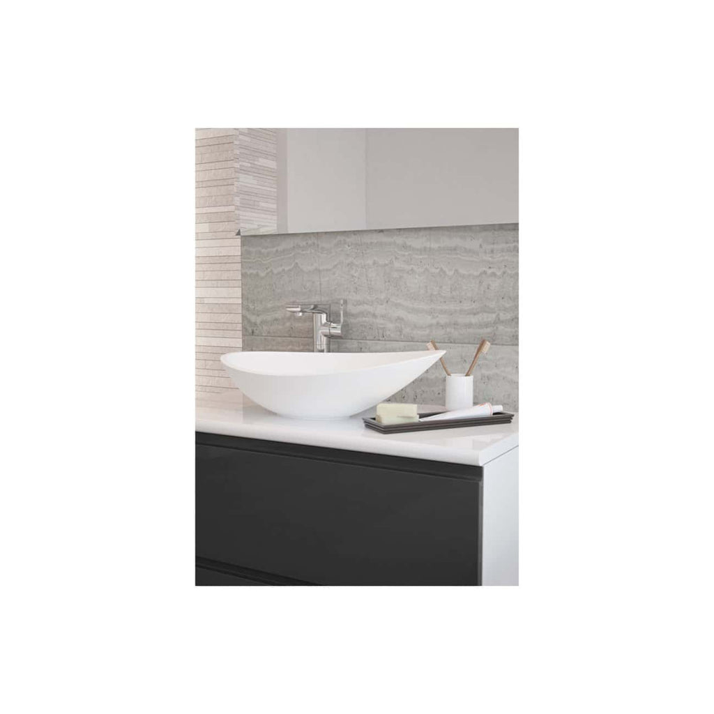 Stylish modern bathroom sink with a sleek white vessel basin, chrome faucet, and contemporary accessories against a textured stone tile wall for a premium bathroom renovation.